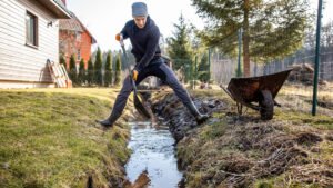 man doing his yard drainage by himself