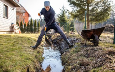 man doing his yard drainage by himself