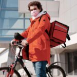 man delivering food on bicycle